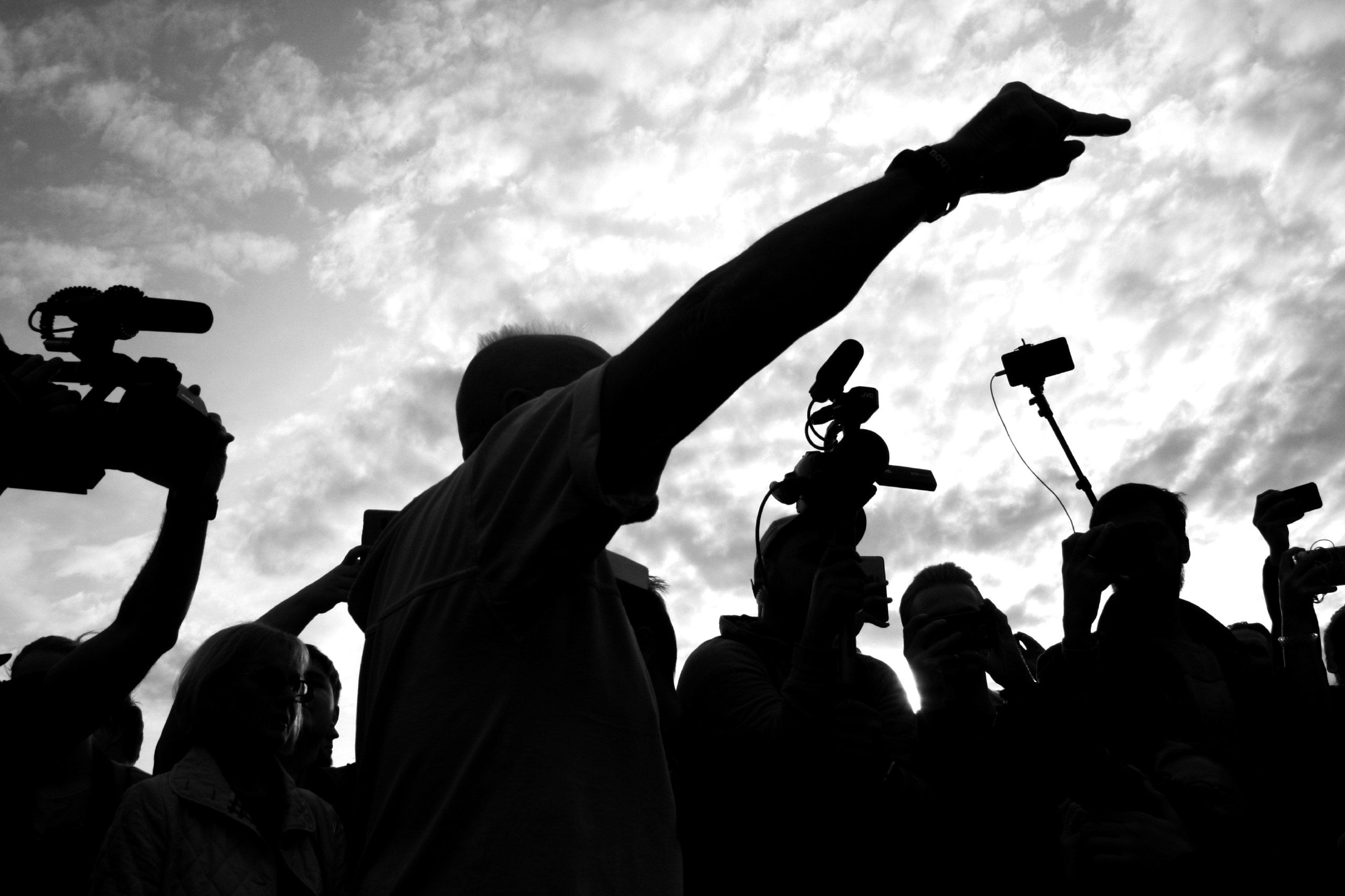 Media crew recording an interview outdoors, representing journalism and public accountability