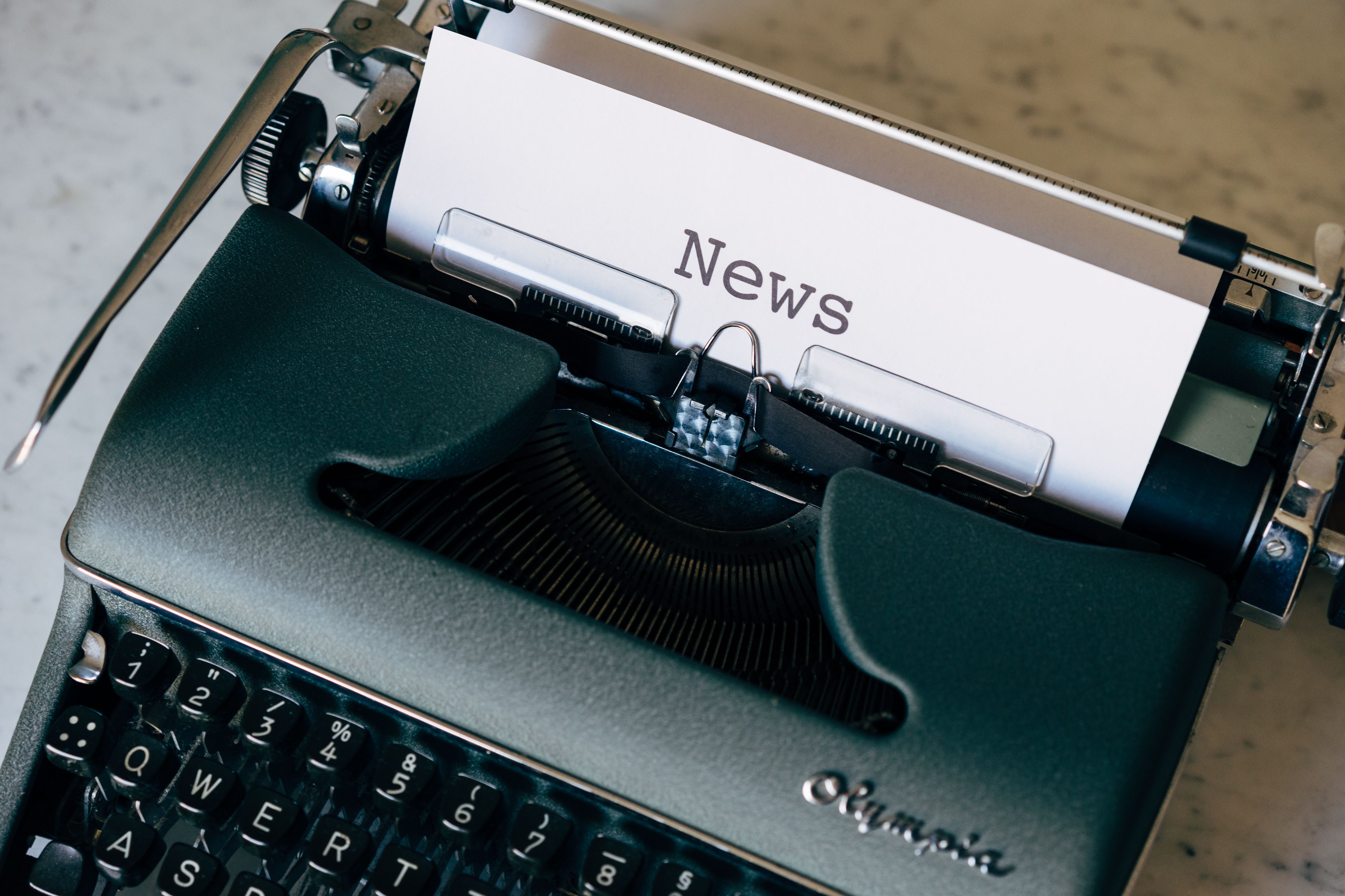 Vintage typewriter with a page labeled News, symbolizing journalism and news reporting